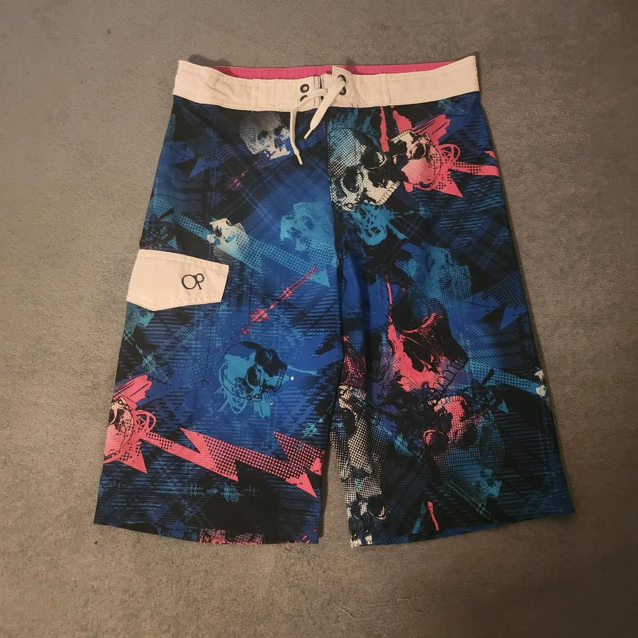 Ocean Pacific men's multi swim briefs shorts laid flat